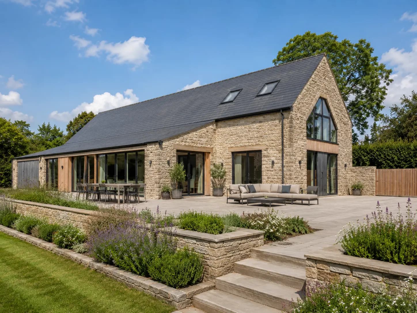 Stone residential conversion with contemporary glazing and landscaped terrace
